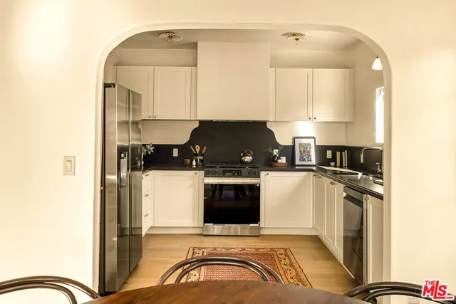 a kitchen with a stove and a refrigerator