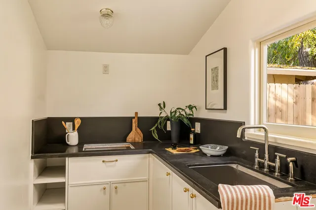 a kitchen with a sink and a stove top oven