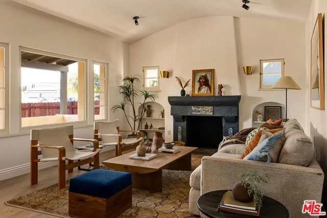 a living room with furniture and a fireplace