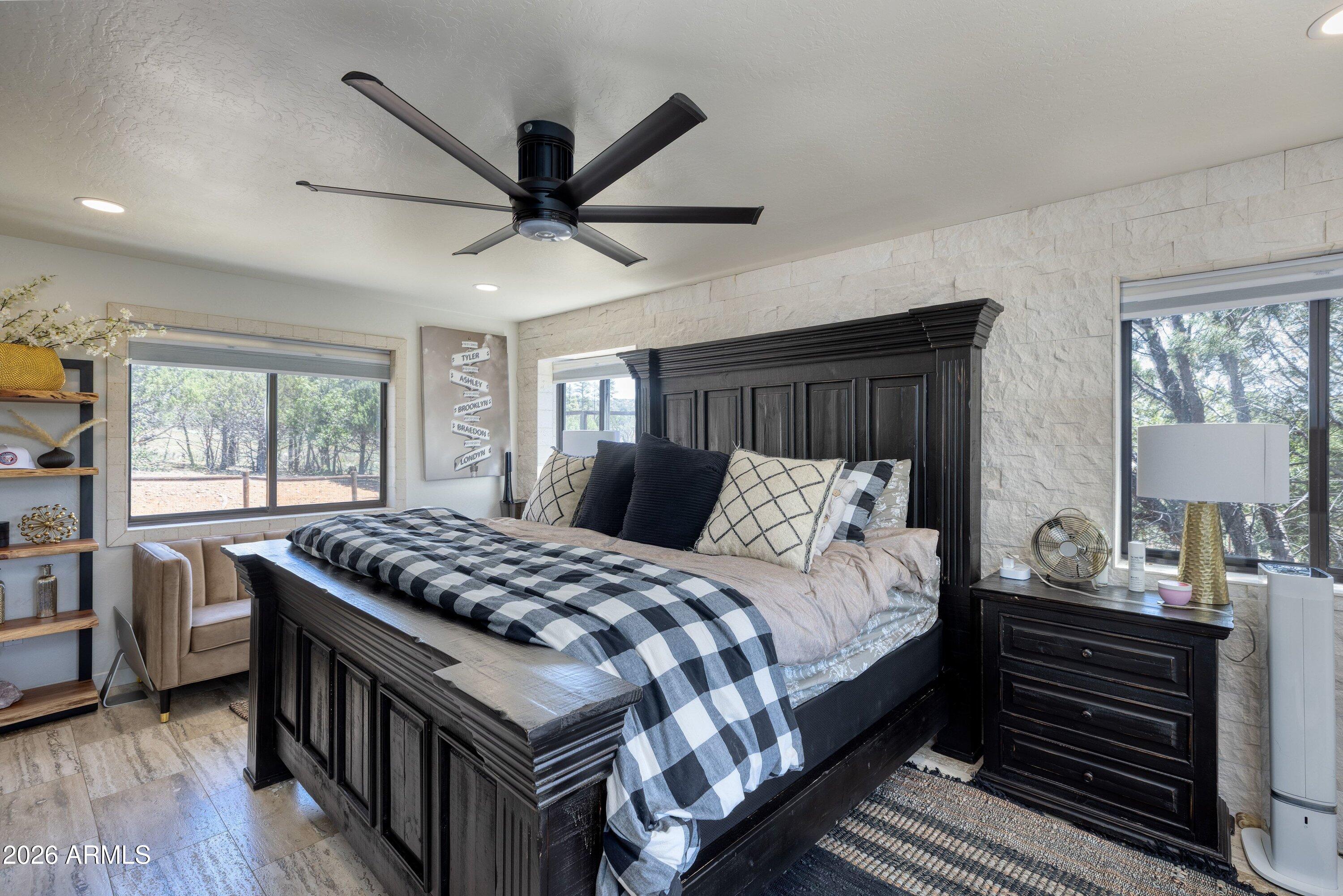 5182 Pinedale Wash Road Pinedale, AZ 85934 - Photo 21 of 54 a bedroom with a bed and a chandelier