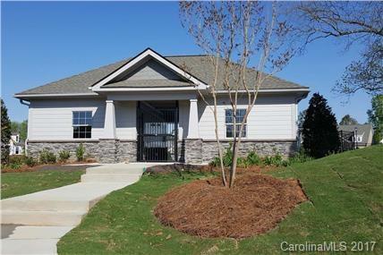 5089 Waterloo Drive, Unit 75 Tega Cay, SC 29708 - Photo 2 of 2 a front view of a house with garden