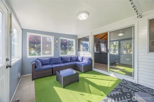 a living room with furniture and a large window