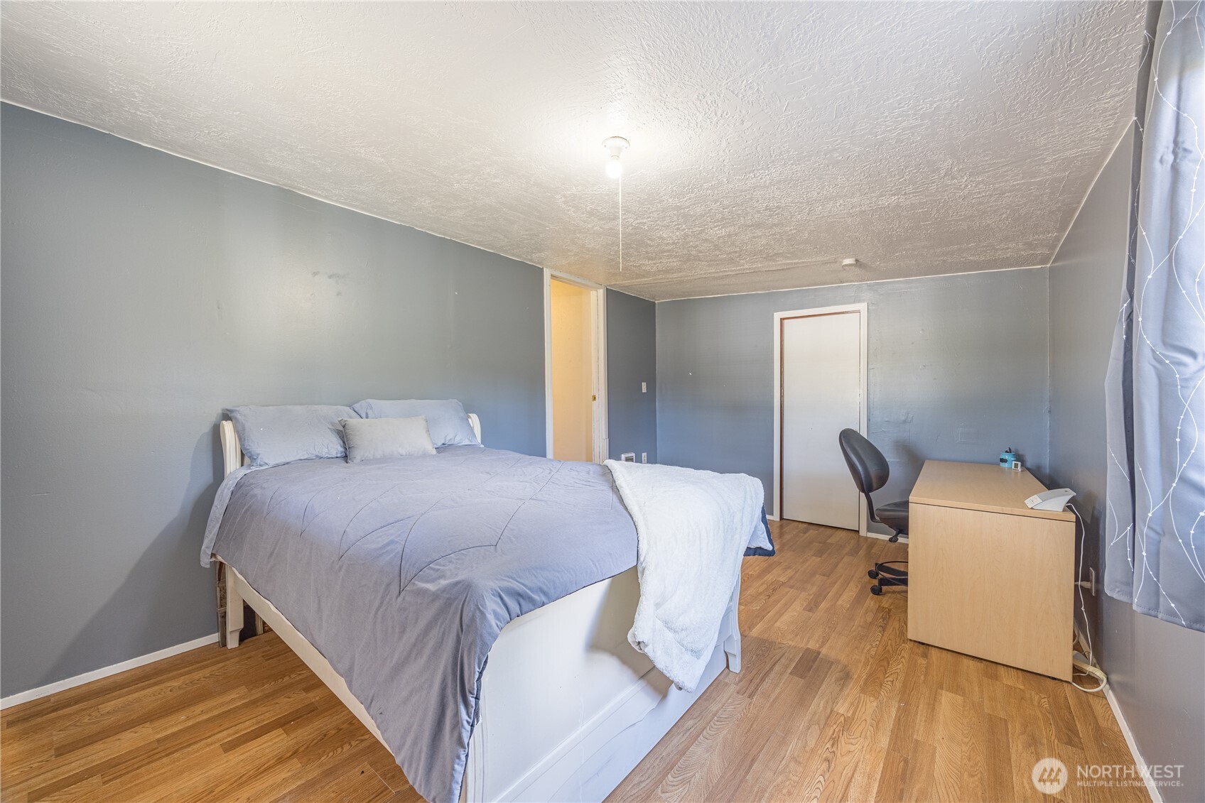 642 Kitchen-Dick Road Sequim, WA 98382 - Photo 23 of 40 a bedroom with a bed and wooden floor