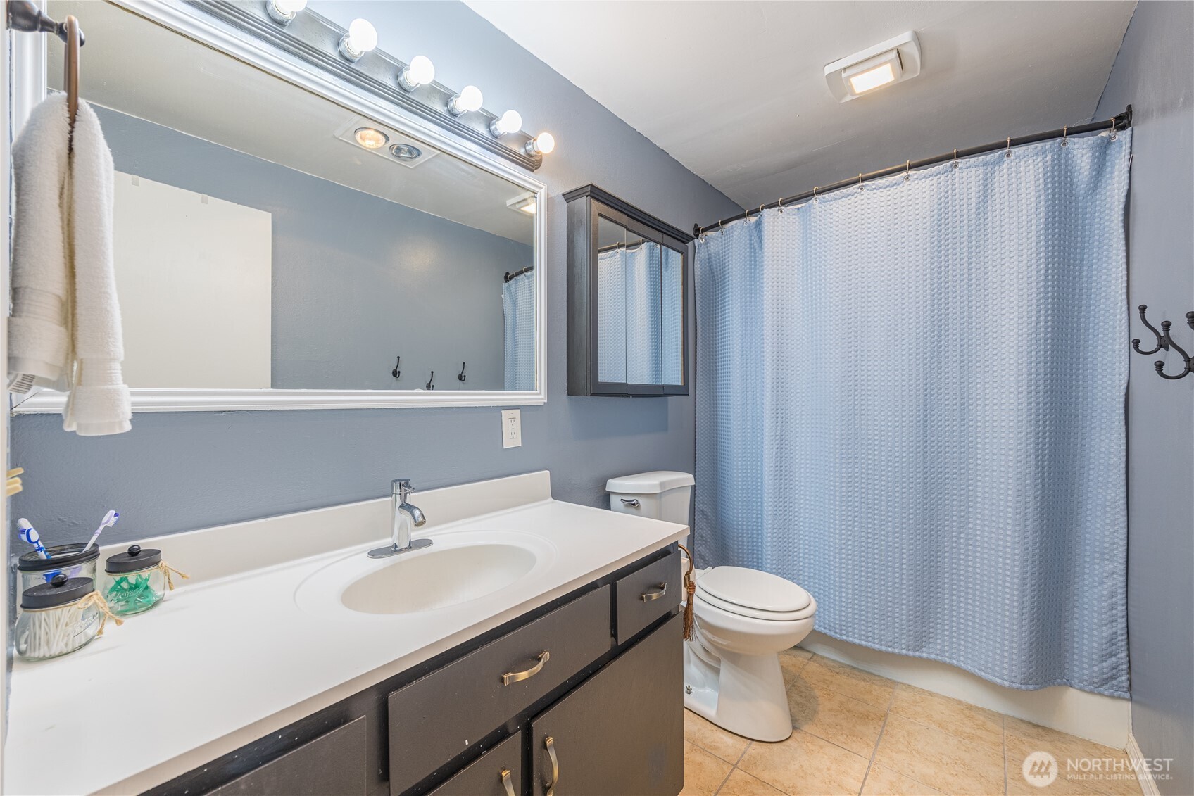 642 Kitchen-Dick Road Sequim, WA 98382 - Photo 24 of 40 a bathroom with a sink a toilet and mirror