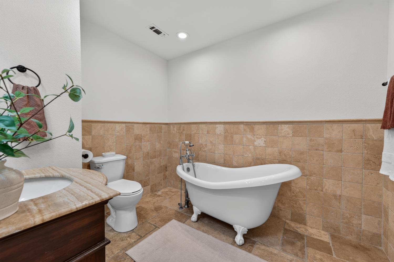 4335 Walnut Avenue Sacramento, CA 95821 - Photo 37 of 62 classic clawfoot soaking tub with natural stone finishes.