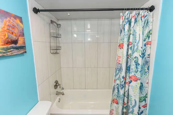 a bathroom with a bathtub and shower