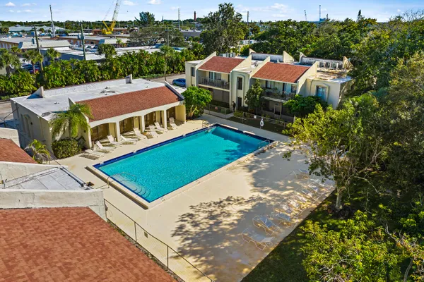 a view of a big house with a big yard and large trees