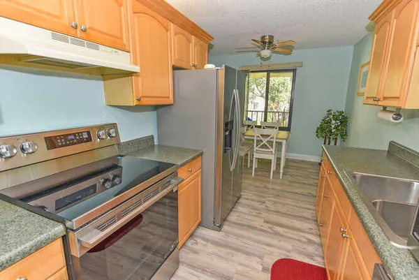 a kitchen with wooden floors and a sink