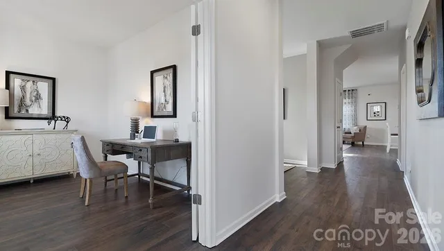 a view of a livingroom with furniture and hardwood floor