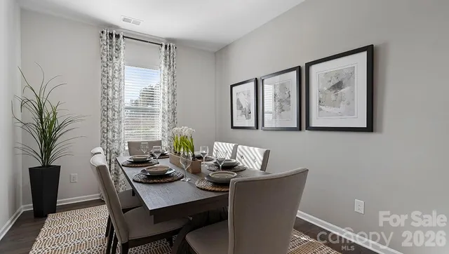 a dining room with furniture and window