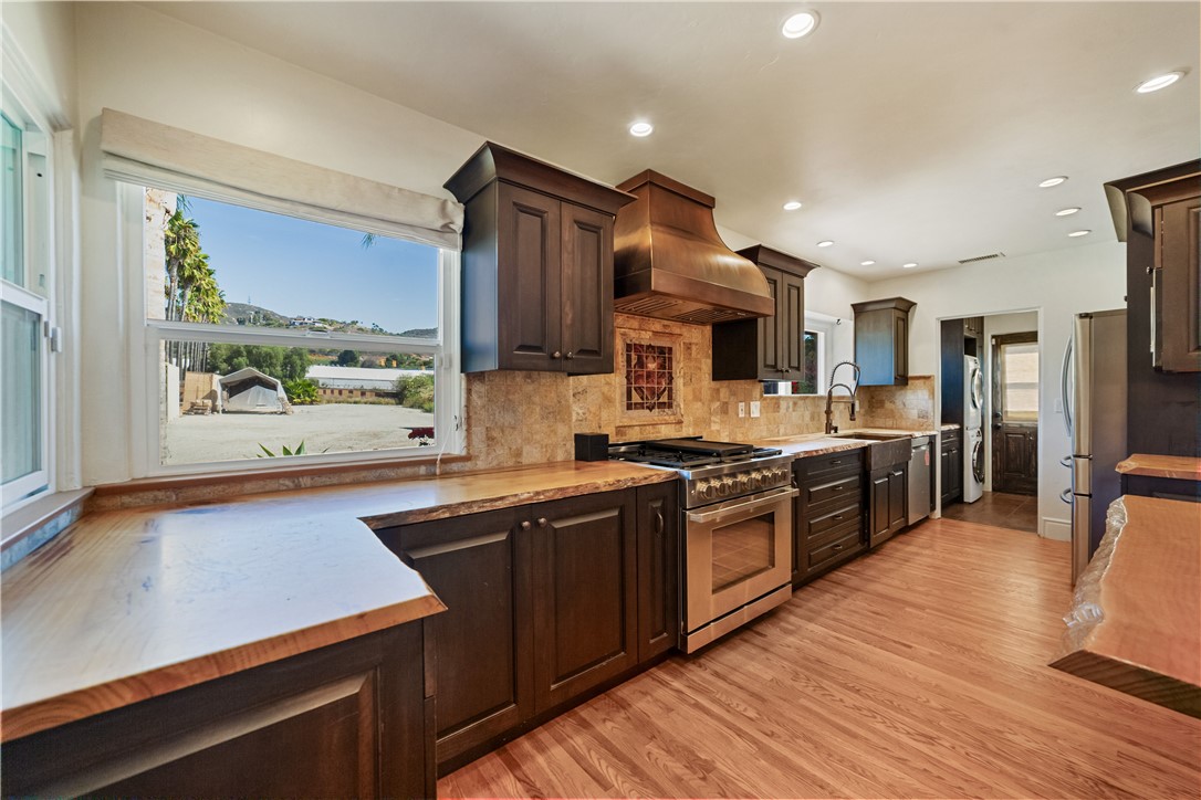 1955 Friendly Drive Vista, CA 92084 - Photo 16 of 75 outdoor kitchen with stainless steel appliances granite countertop a sink stove and refrigerator