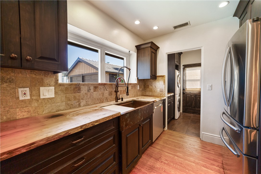 1955 Friendly Drive Vista, CA 92084 - Photo 17 of 75 a kitchen with stainless steel appliances granite countertop a refrigerator a sink and a stove