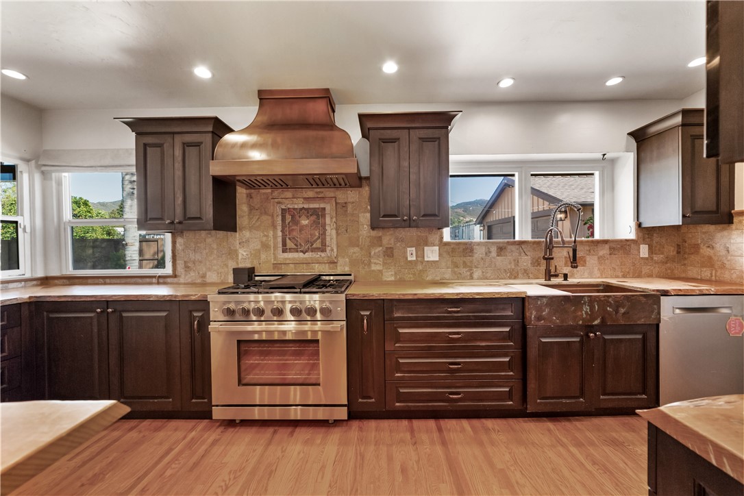 1955 Friendly Drive Vista, CA 92084 - Photo 18 of 75 a kitchen with stainless steel appliances granite countertop a stove and a sink