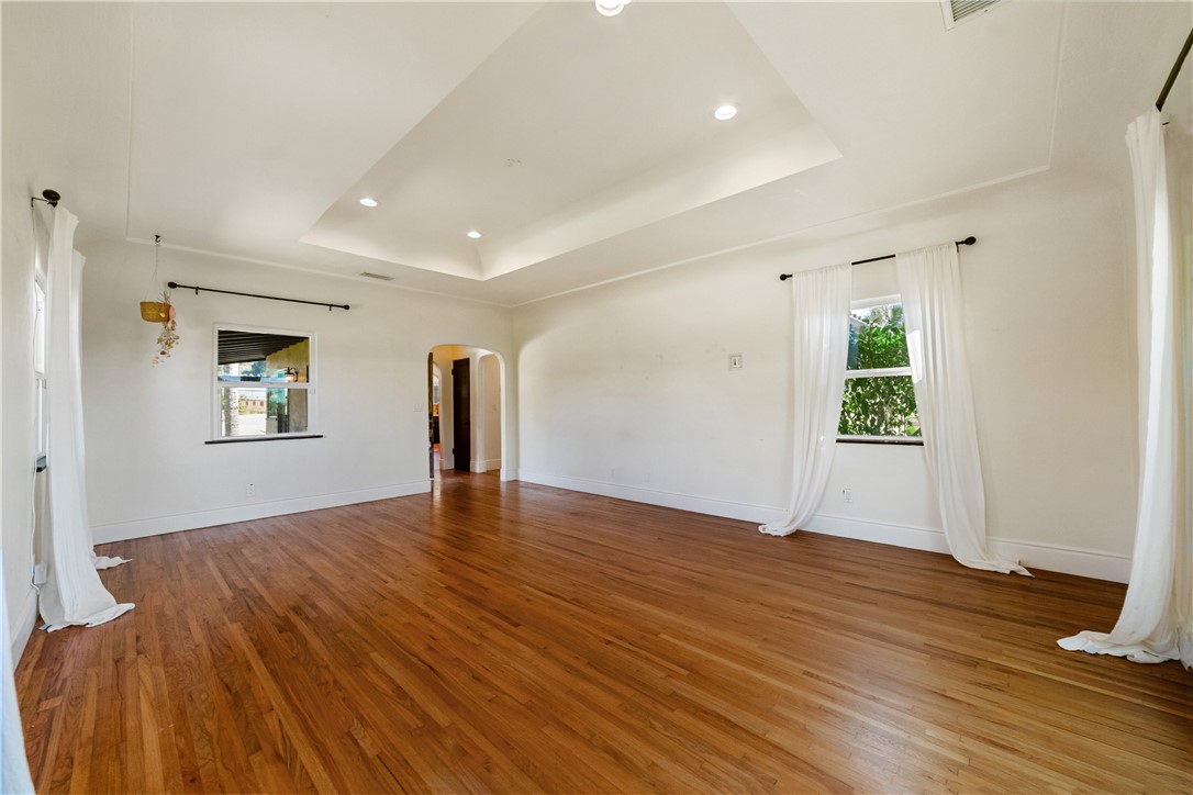 1955 Friendly Drive Vista, CA 92084 - Photo 22 of 75 a view of an empty room with wooden floor and a window