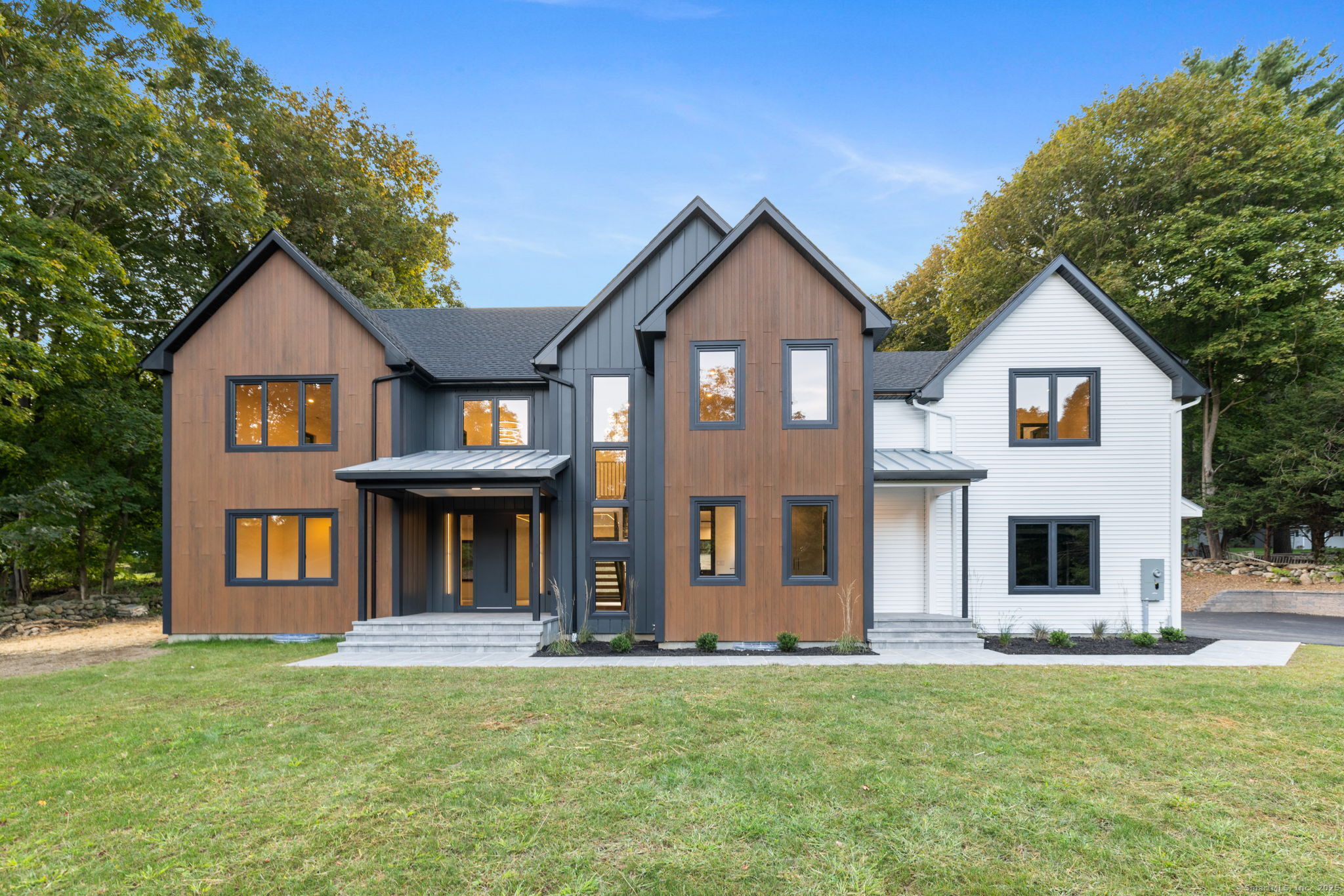 a front view of a house with a garden