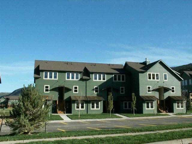 a front view of a residential apartment building with a yard