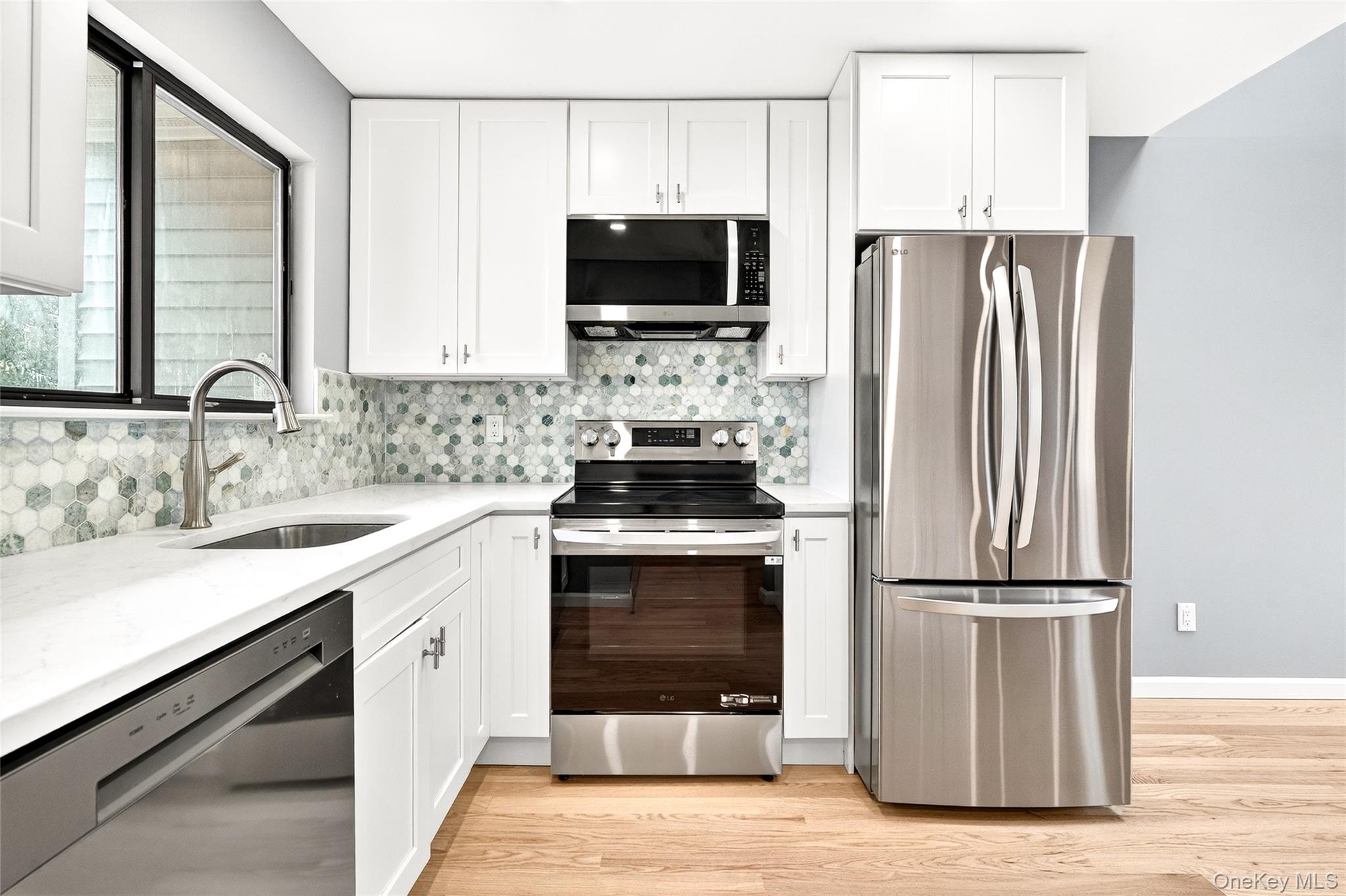 14 Bridle Path Road Ossining, NY 10562 - Photo 12 of 45 a kitchen with a refrigerator and a sink