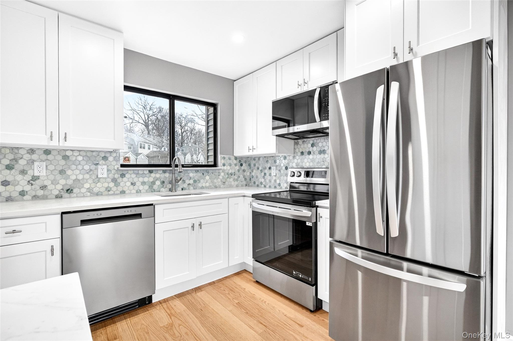 14 Bridle Path Road Ossining, NY 10562 - Photo 14 of 45 a kitchen with stainless steel appliances a refrigerator sink and microwave