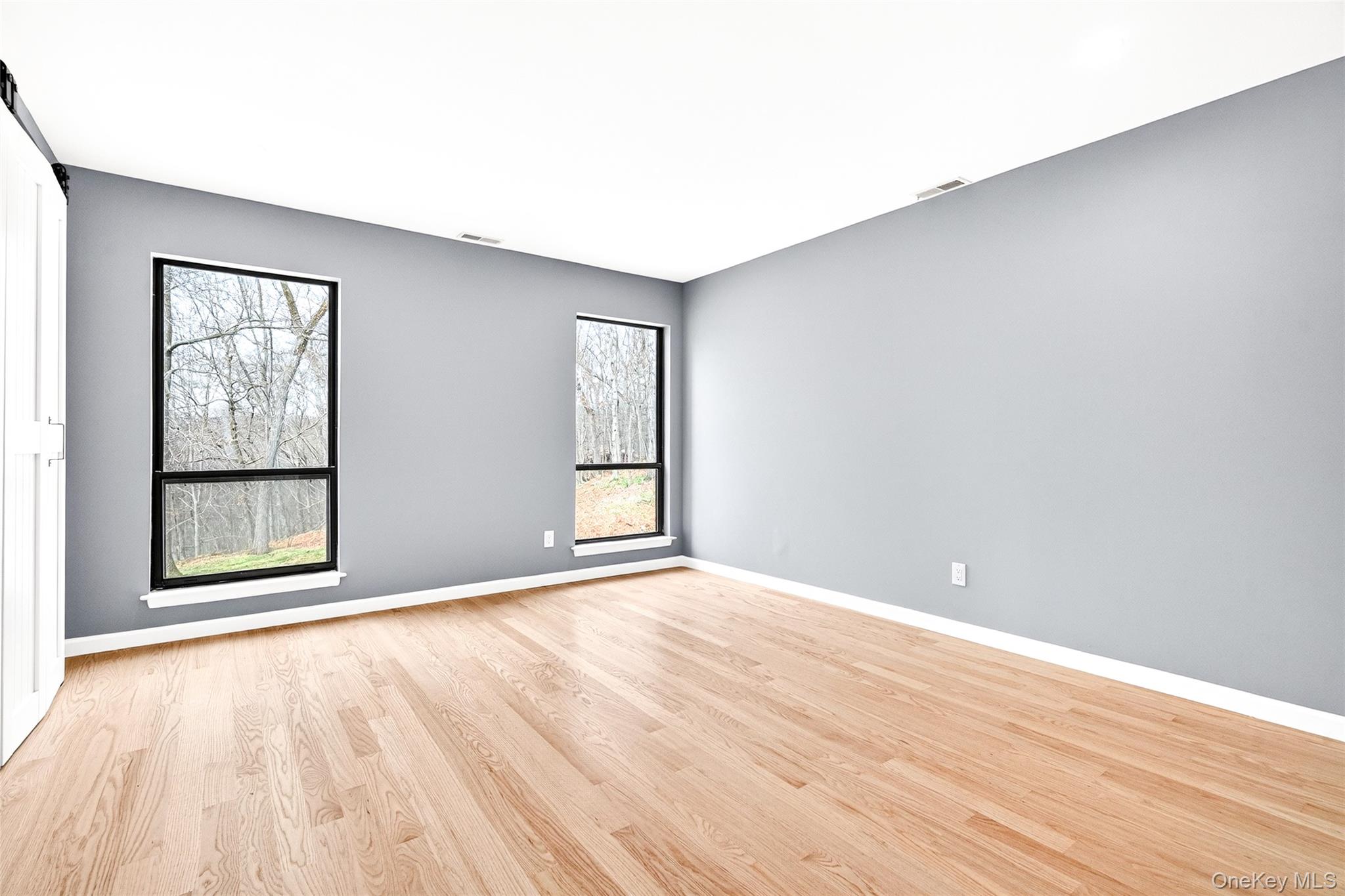 14 Bridle Path Road Ossining, NY 10562 - Photo 21 of 45 an empty room with wooden floor and windows