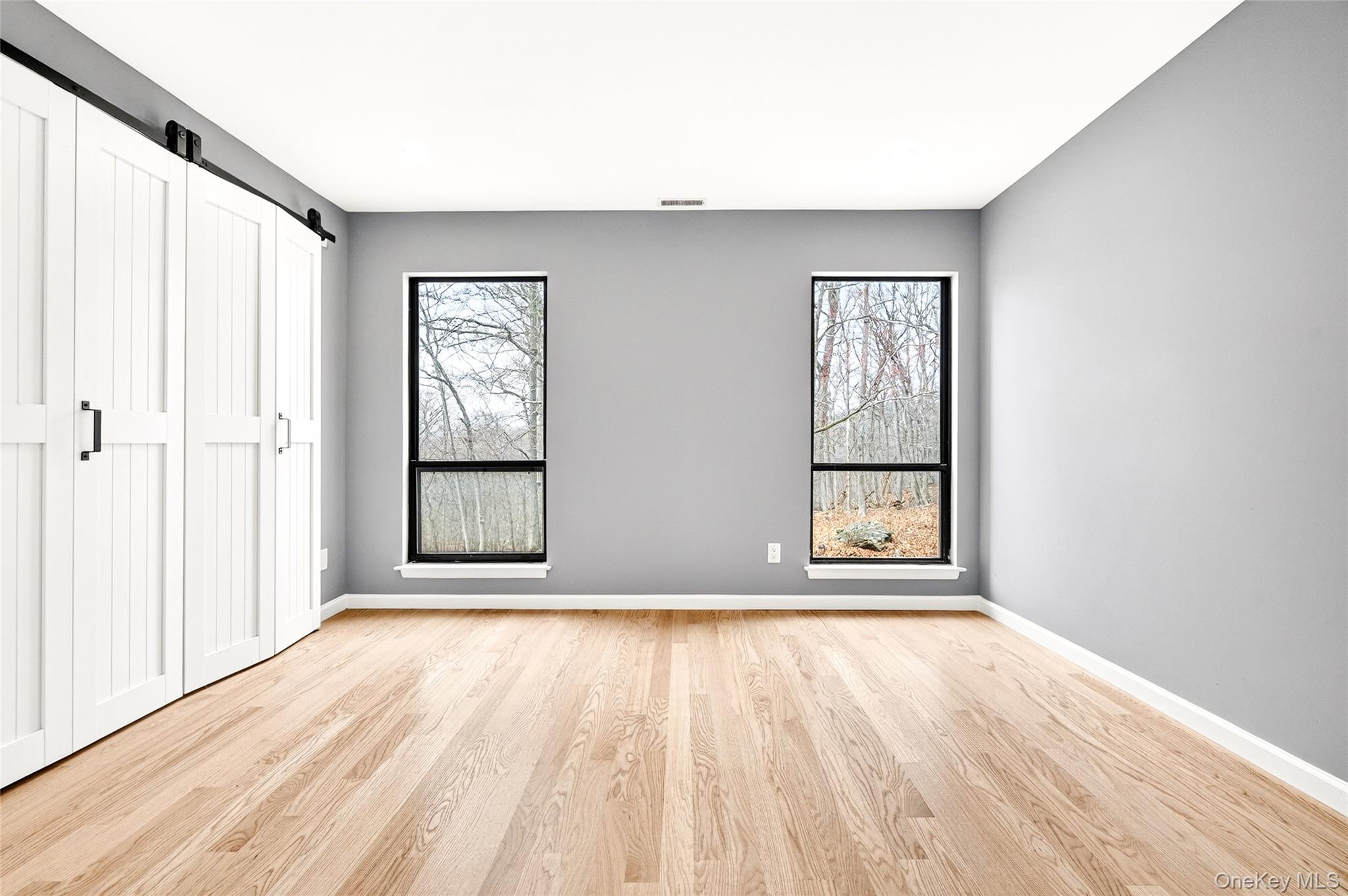 14 Bridle Path Road Ossining, NY 10562 - Photo 25 of 45 an empty room with wooden floor and windows