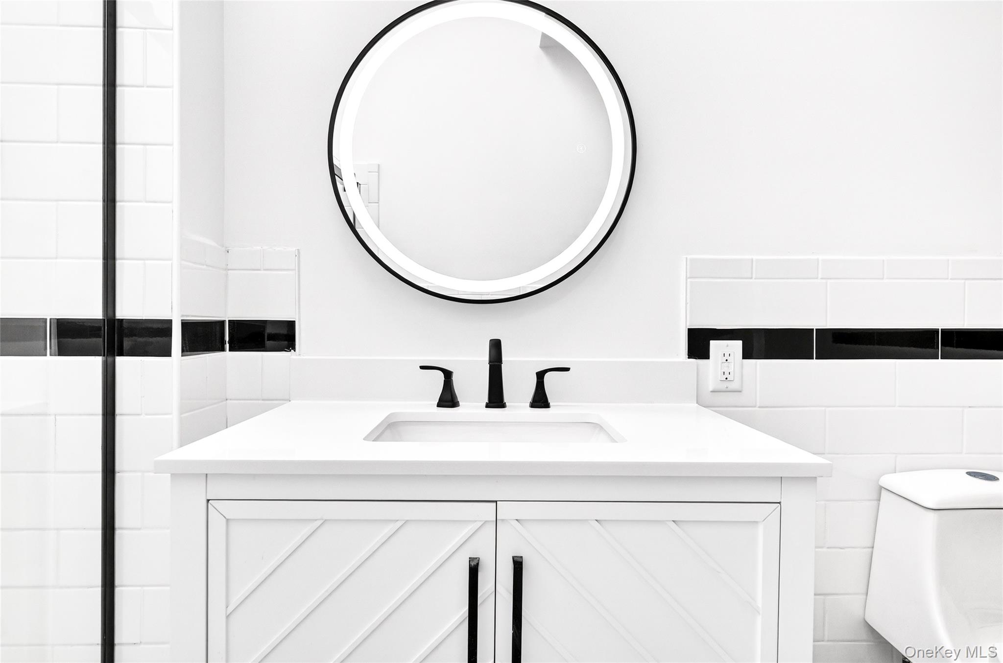 14 Bridle Path Road Ossining, NY 10562 - Photo 29 of 45 a bathroom with a sink a toilet and a mirror