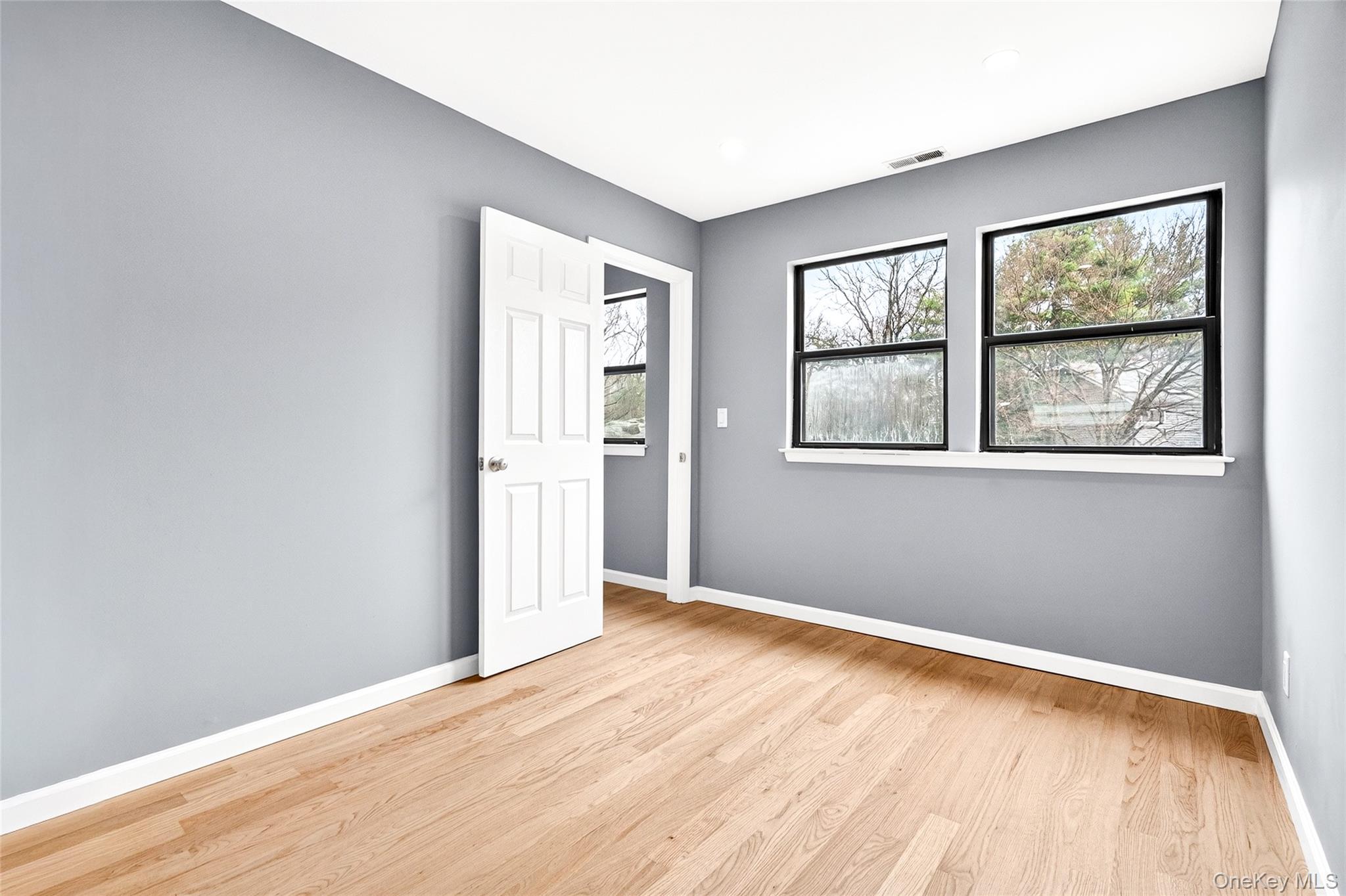14 Bridle Path Road Ossining, NY 10562 - Photo 33 of 45 an empty room with wooden floor and windows