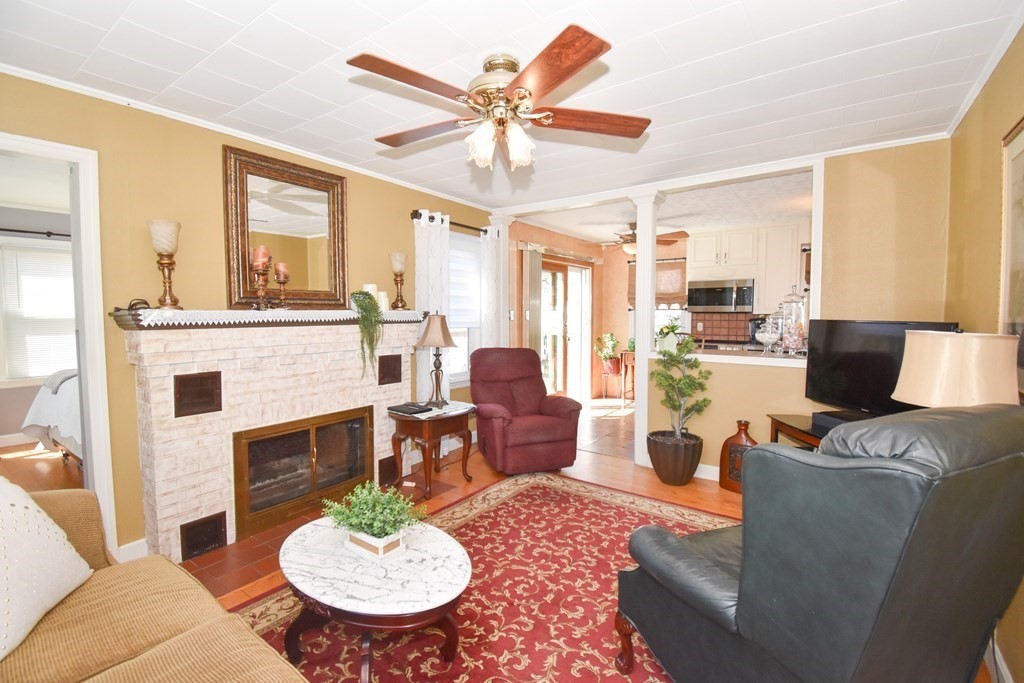 276 Oak Street Springfield, MA 01151 - Photo 11 of 36 a living room with furniture a fireplace and a large window