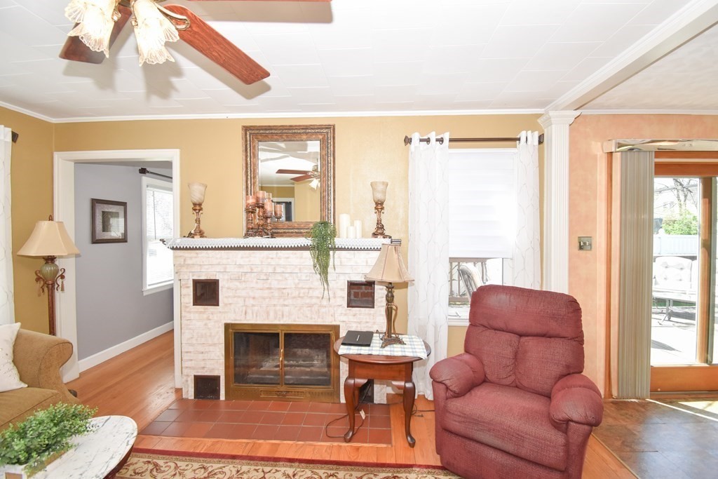 276 Oak Street Springfield, MA 01151 - Photo 12 of 36 a living room with furniture a large window and a fireplace