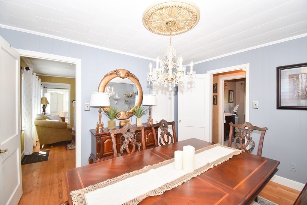276 Oak Street Springfield, MA 01151 - Photo 15 of 36 a view of a dining room with furniture a chandelier and wooden floor