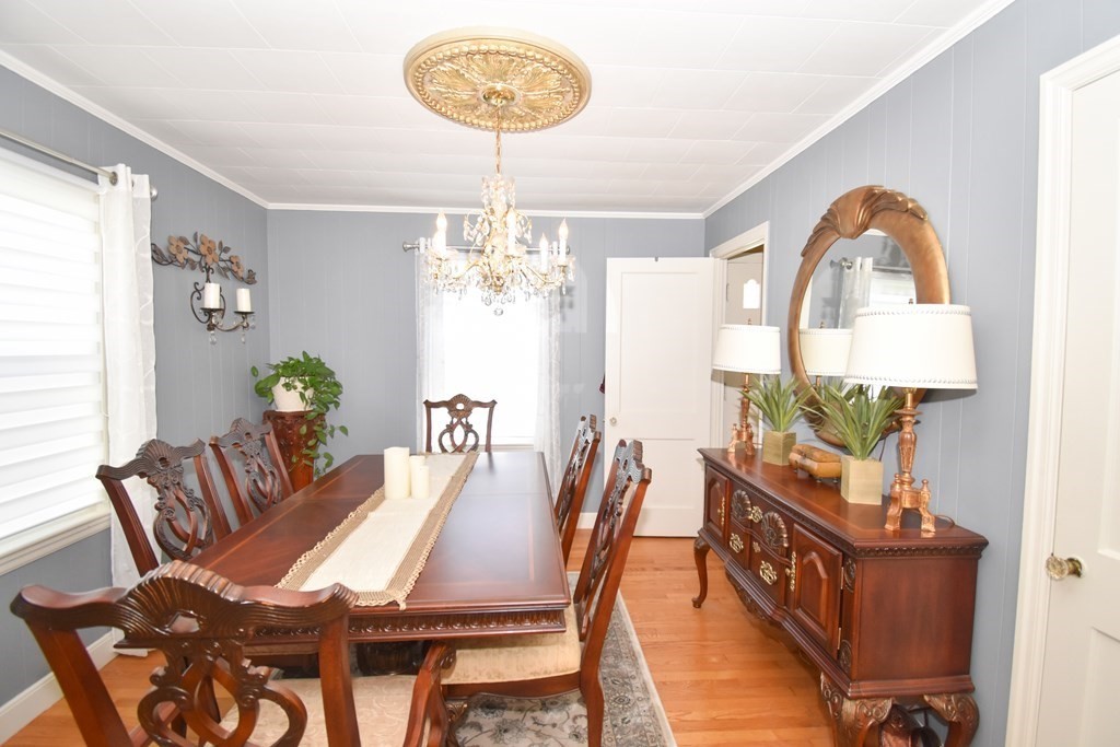 276 Oak Street Springfield, MA 01151 - Photo 16 of 36 a view of a dining room with furniture a chandelier and wooden floor