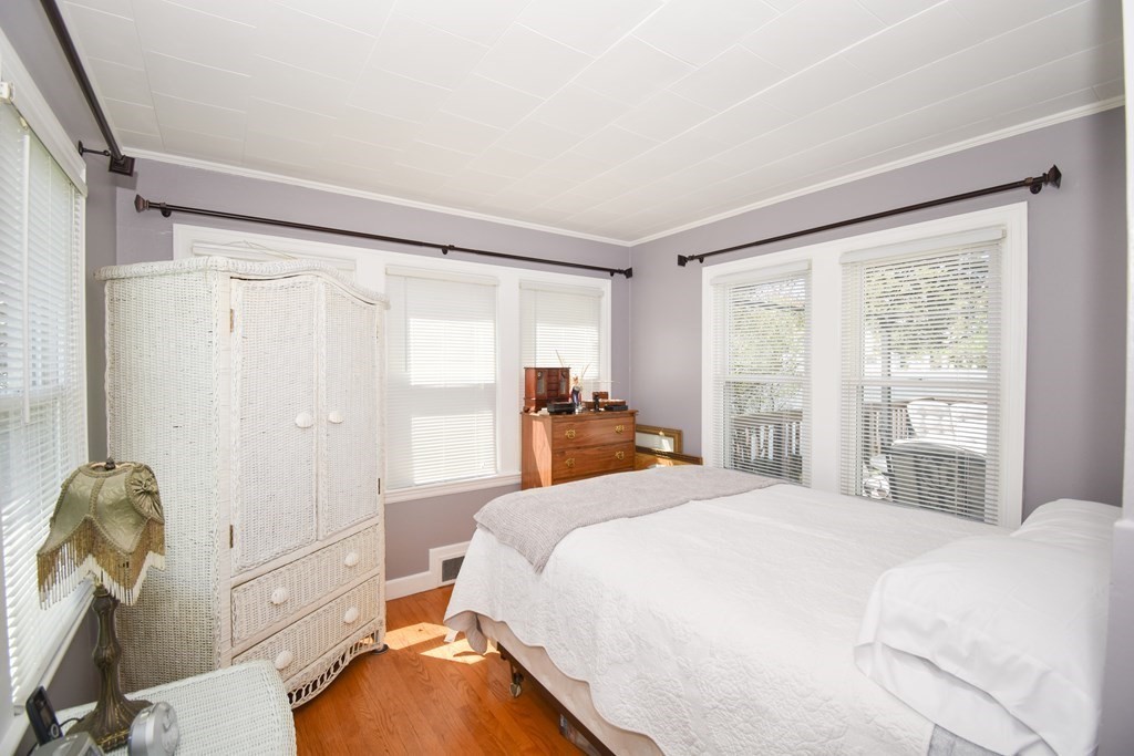 276 Oak Street Springfield, MA 01151 - Photo 19 of 36 a bedroom with a bed and a dresser next to a large window