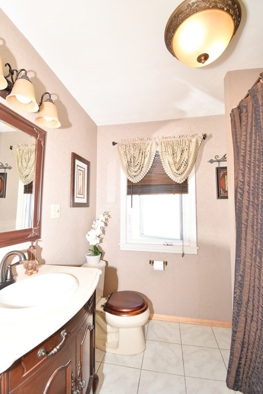 276 Oak Street Springfield, MA 01151 - Photo 21 of 36 a bathroom with a granite countertop sink and a mirror