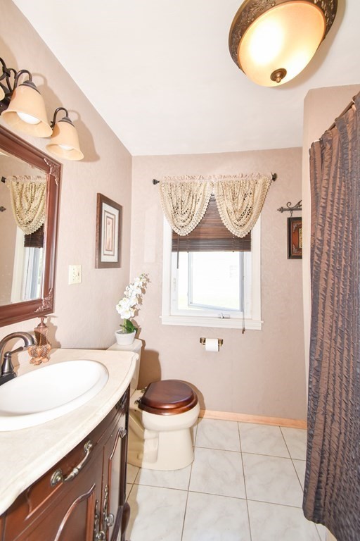 276 Oak Street Springfield, MA 01151 - Photo 22 of 36 a bathroom with a granite countertop sink and a mirror