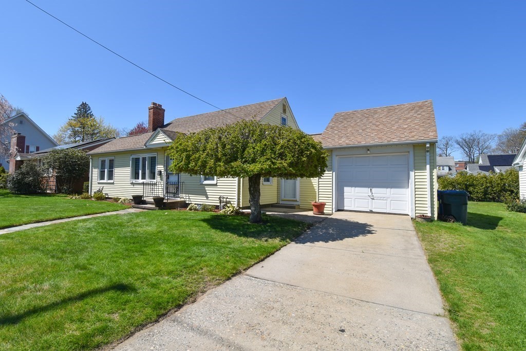 276 Oak Street Springfield, MA 01151 - Photo 3 of 36 a front view of a house with a yard and garage