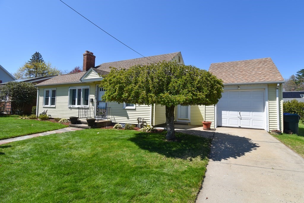 276 Oak Street Springfield, MA 01151 - Photo 35 of 36 a front view of a house with a garden and patio