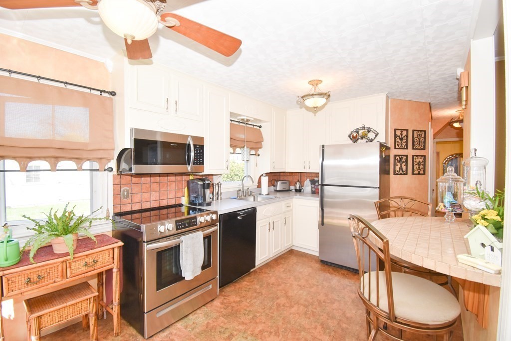276 Oak Street Springfield, MA 01151 - Photo 4 of 36 a kitchen with a sink stove and refrigerator
