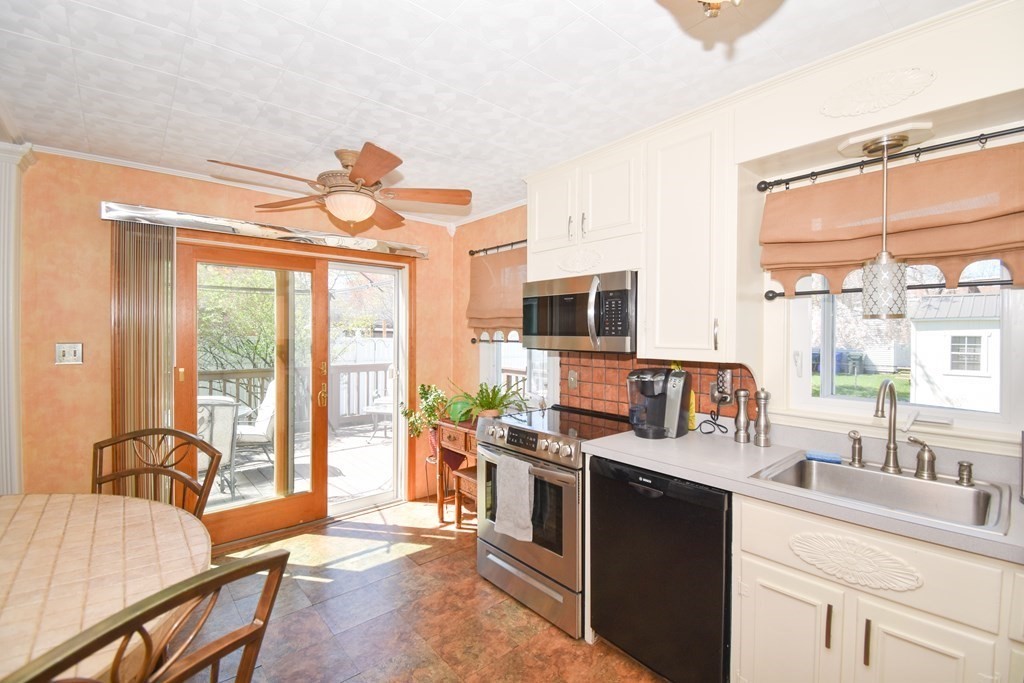 276 Oak Street Springfield, MA 01151 - Photo 5 of 36 a kitchen with stainless steel appliances a stove a sink and white cabinets