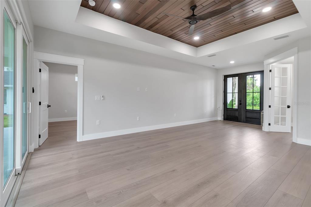 776 Cypress Road Venice, FL 34293 - Photo 18 of 89 an empty room with wooden floor and windows