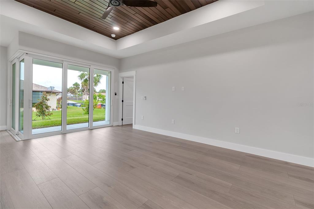 776 Cypress Road Venice, FL 34293 - Photo 19 of 89 a view of empty room with wooden floor and fan