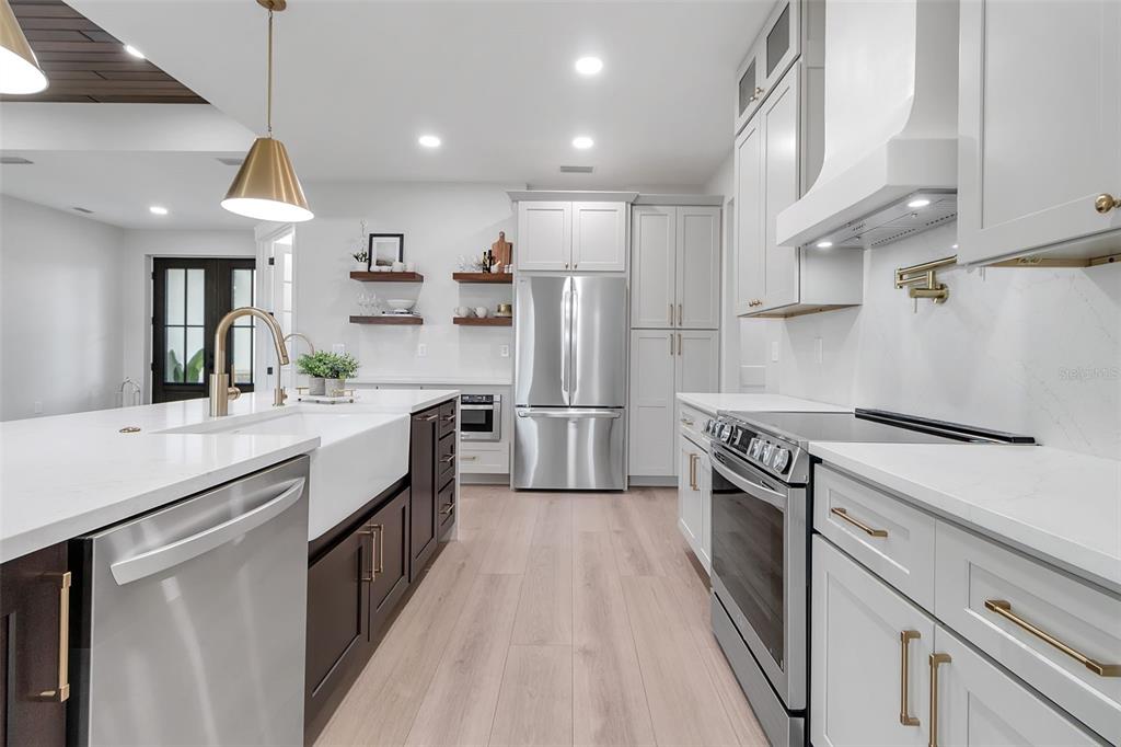 776 Cypress Road Venice, FL 34293 - Photo 27 of 89 a kitchen with stainless steel appliances granite countertop a sink a stove and a refrigerator