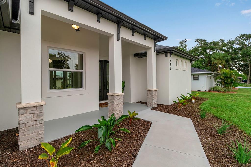 776 Cypress Road Venice, FL 34293 - Photo 3 of 89 a front view of a house with garden
