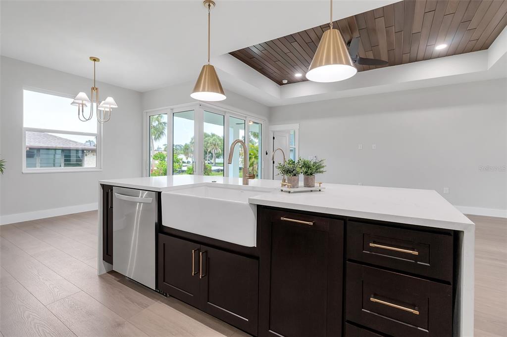 776 Cypress Road Venice, FL 34293 - Photo 32 of 89 a kitchen with stainless steel appliances granite countertop a sink a stove and a window