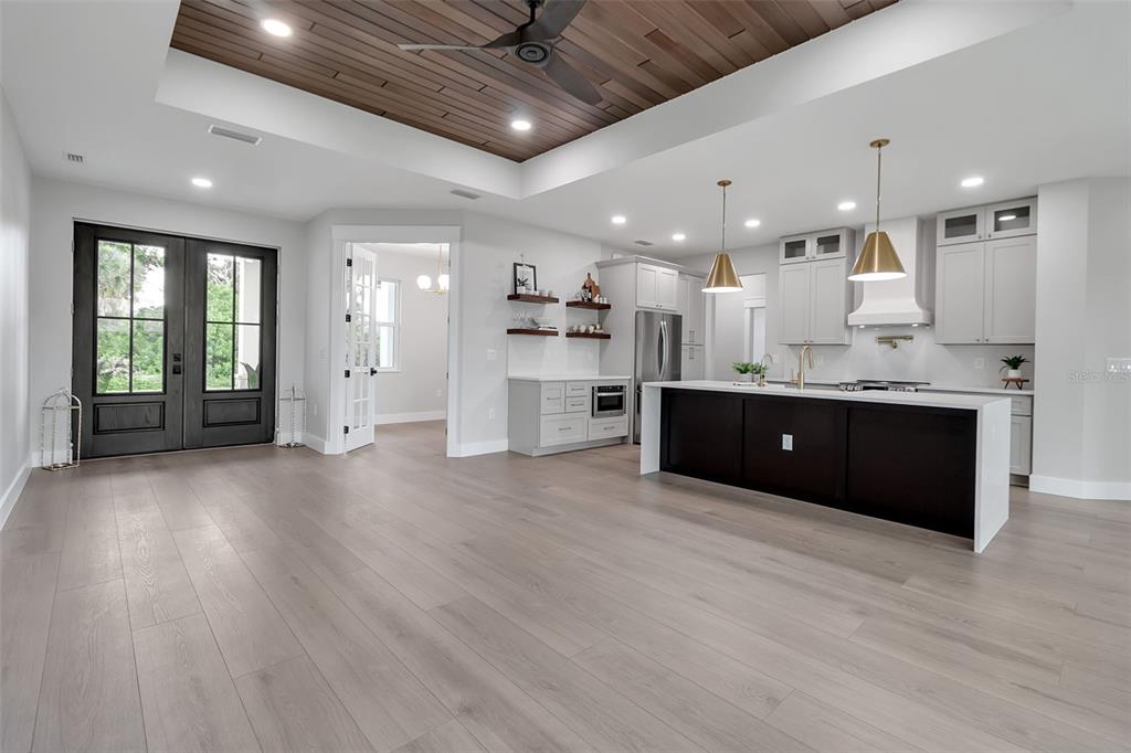 776 Cypress Road Venice, FL 34293 - Photo 4 of 89 a large room with stainless steel appliances kitchen island wooden floors granite counter tops and a view of living room