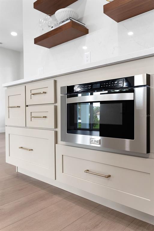 776 Cypress Road Venice, FL 34293 - Photo 42 of 89 a kitchen with white cabinets and stainless steel appliances