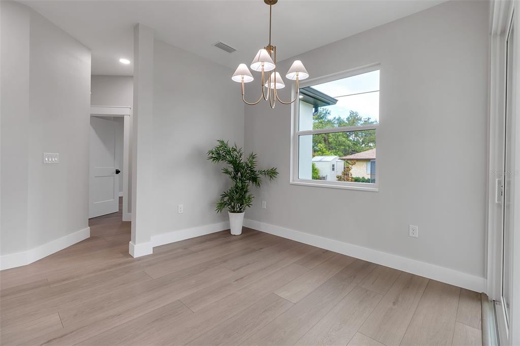 776 Cypress Road Venice, FL 34293 - Photo 45 of 89 a view of an empty room with wooden floor and a window