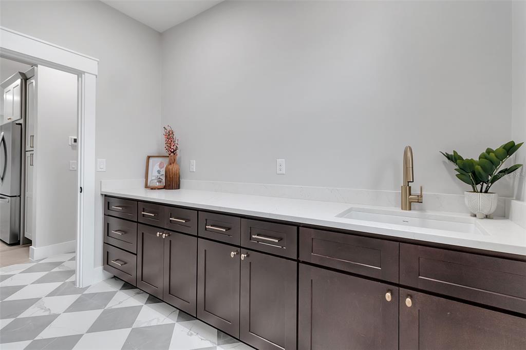 776 Cypress Road Venice, FL 34293 - Photo 55 of 89 a sink with a cabinets and potted plant on it