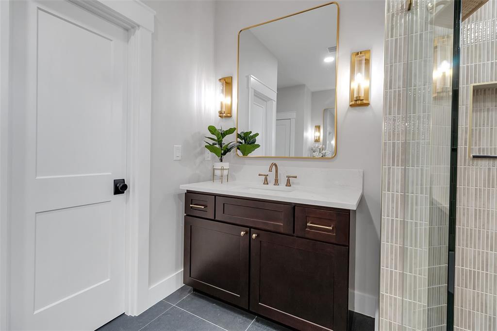776 Cypress Road Venice, FL 34293 - Photo 58 of 89 a bathroom with a sink a potted plant and mirror