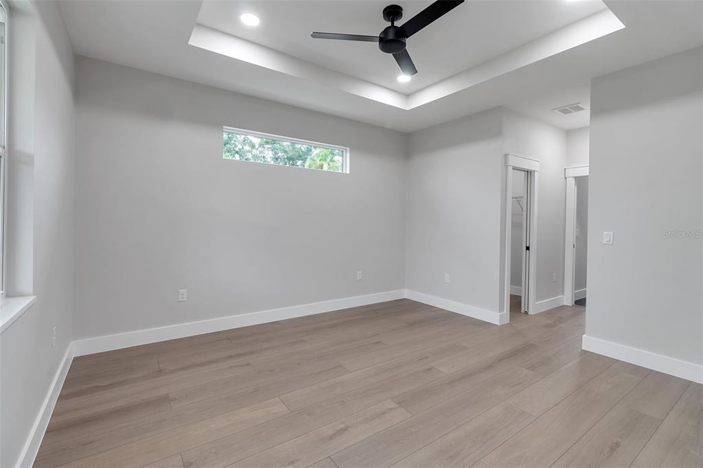 776 Cypress Road Venice, FL 34293 - Photo 60 of 89 an empty room with wooden floor and windows