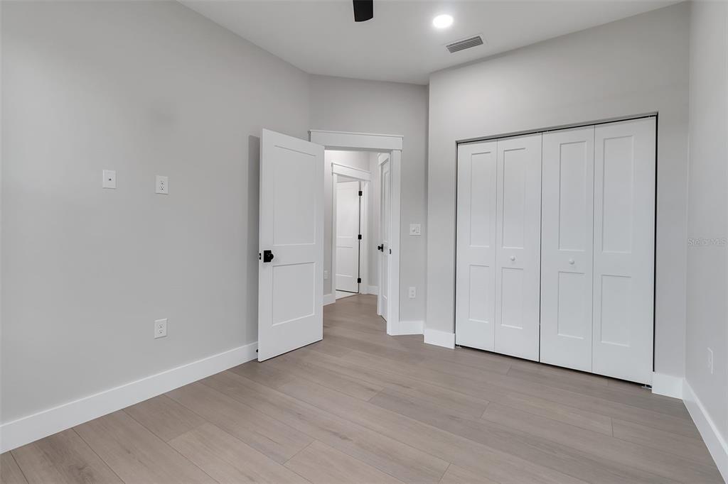 776 Cypress Road Venice, FL 34293 - Photo 76 of 89 a view of an empty room with wooden floor