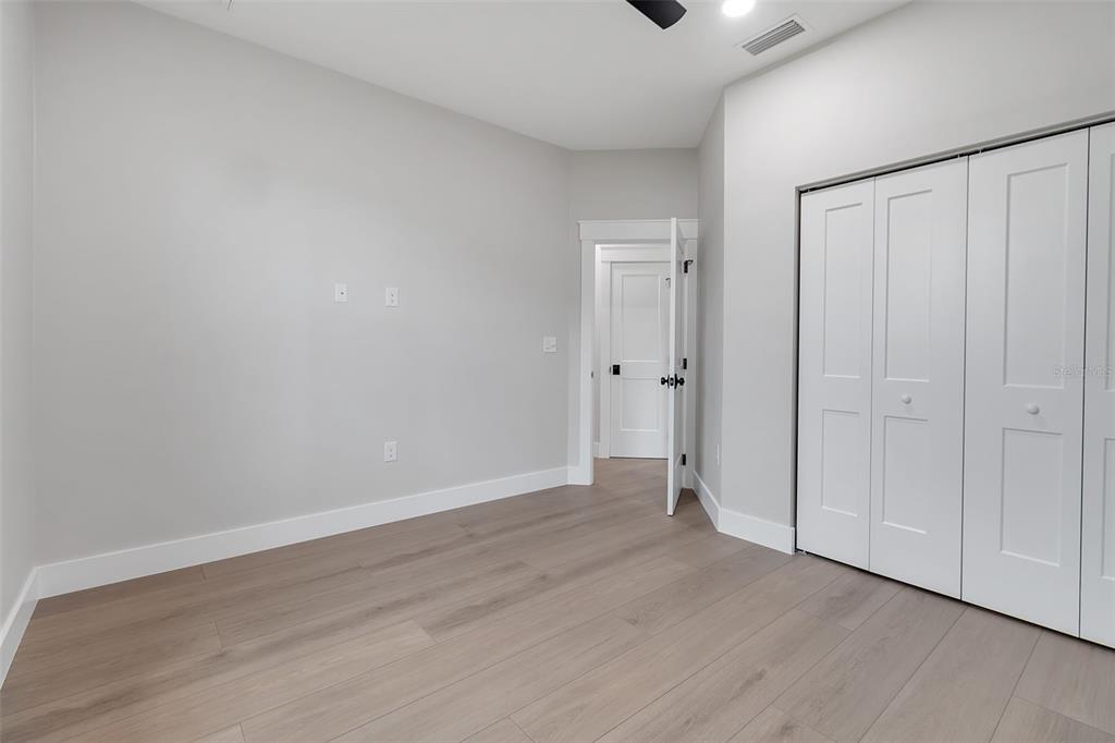 776 Cypress Road Venice, FL 34293 - Photo 78 of 89 a view of an empty room with wooden floor